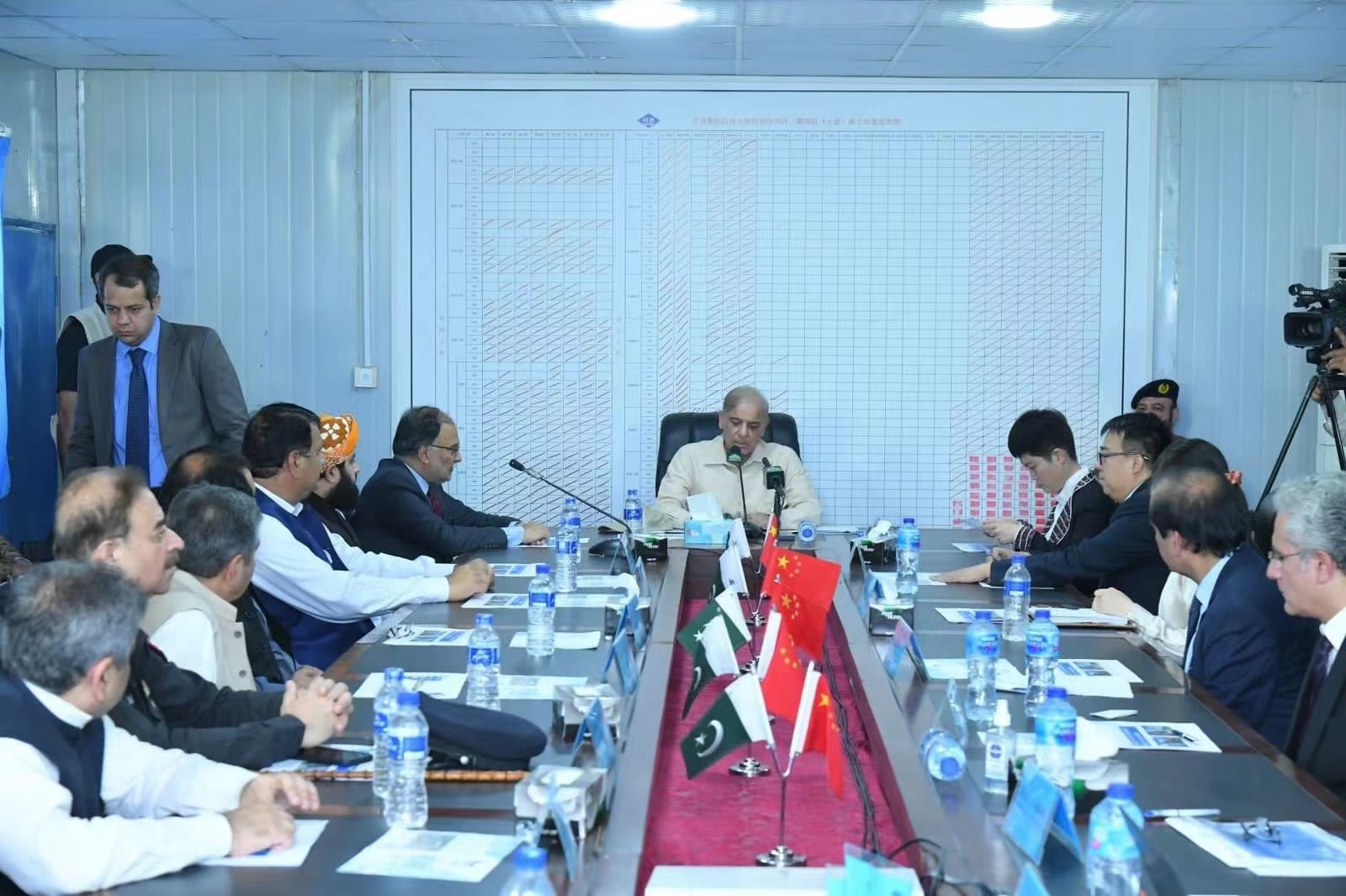 Prime Minister Shahbaz Sharif meeting at Century Steel with Pakistan and China flags